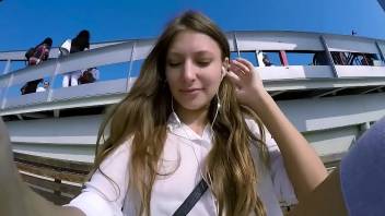 Talia Mint plays in public with remote control toy over the phone with fan